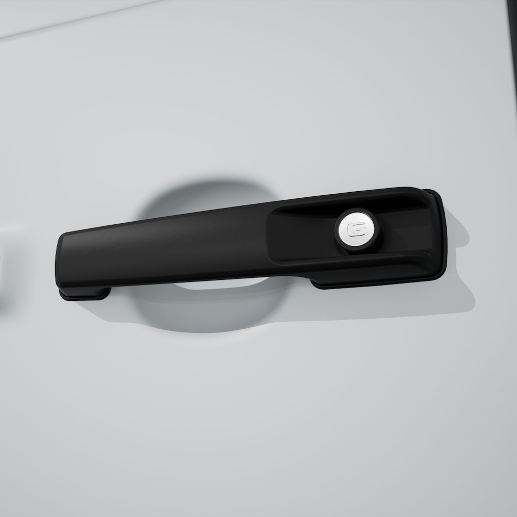 Grande plano de um puxador da porta MANUFAKTUR em preto com logótipo gravado em relevo.