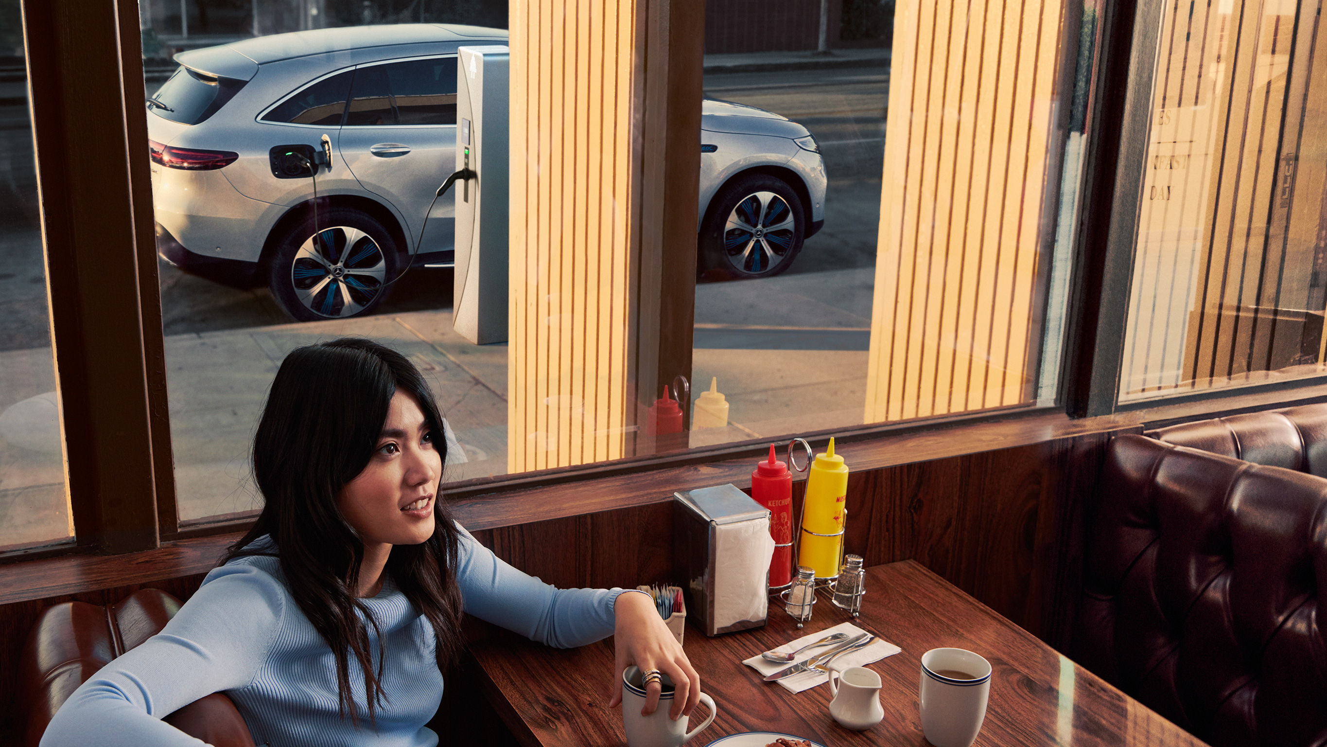 Mercedes-Benz Public Charging Pessoa espera no restaurante enquanto um Mercedes-Benz está a carregar